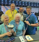 Photograph of bats members Sue Ian Andrea and 2 members of the Intel team who won the over all competition. Sue is holding a winner's trophy and all the members are wearing their winning medals.